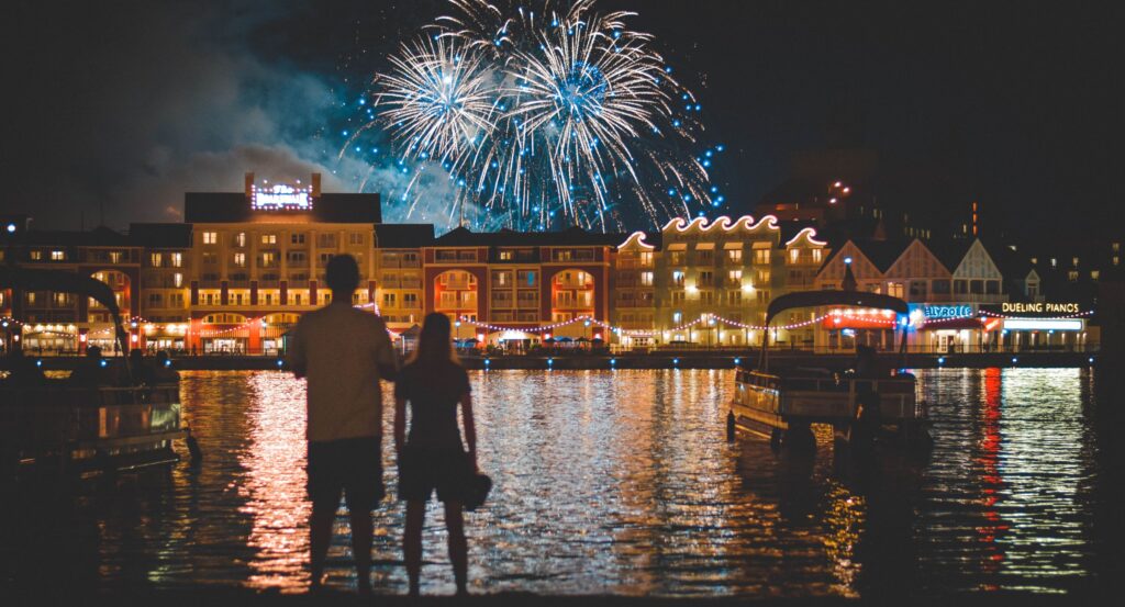 A picture of a couple in front of fireworks. The background and setting makes everything seem like magic.